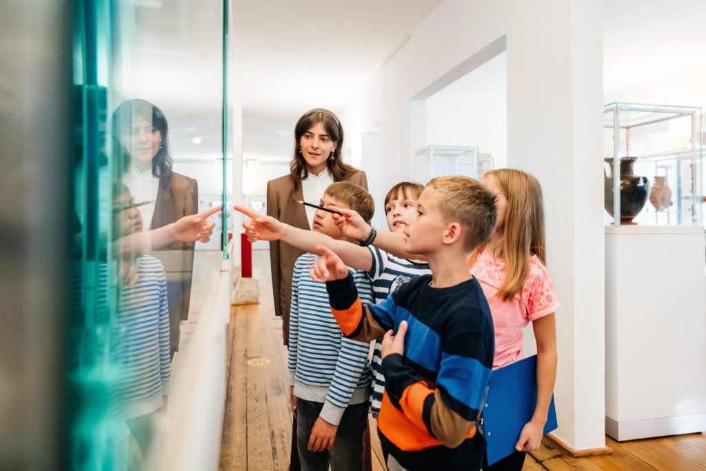 Kids Looking At Objects On Display In Museum