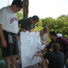 A photo of Tim Mahoney pointing a map